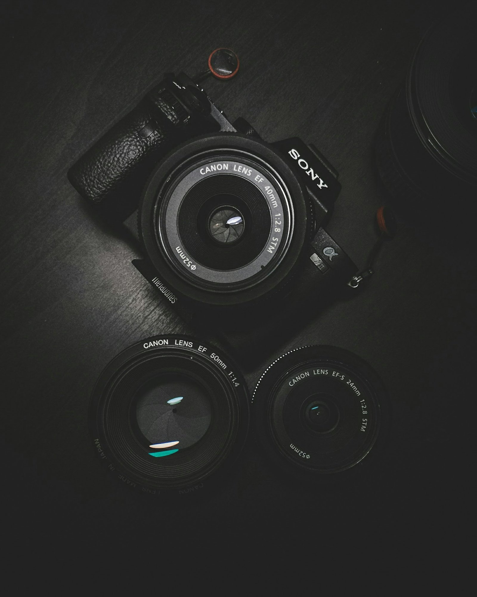 A DSLR camera on a black surface.